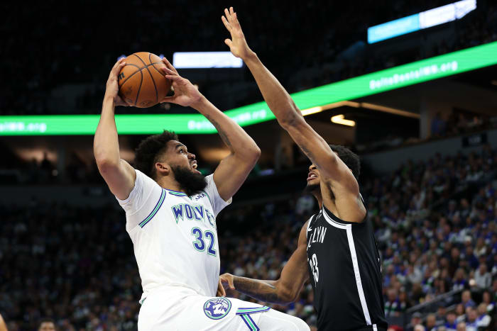 Minnesota Timberwolves center Karl-Anthony Towns (32) shoots as Brooklyn Nets center Nic Claxton (33) defends during the first half at Target Center in Minneapolis on Feb. 24, 2024.
